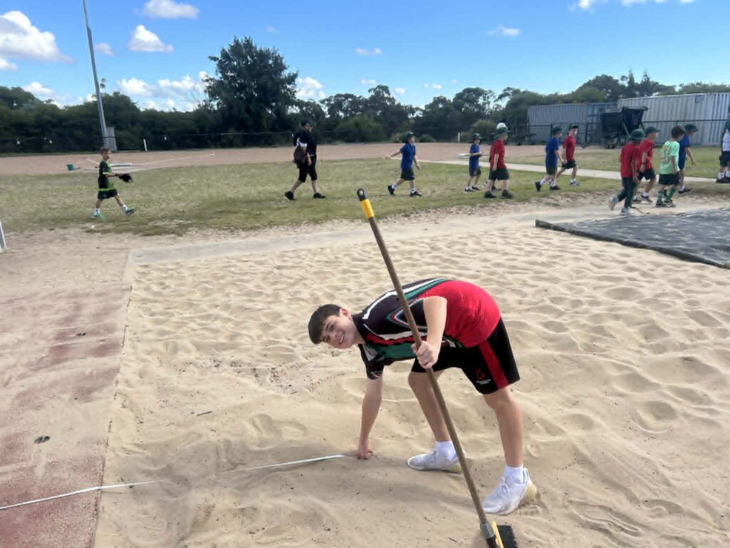 Hands-on learning in action as students support field events with enthusiasm and responsibility.