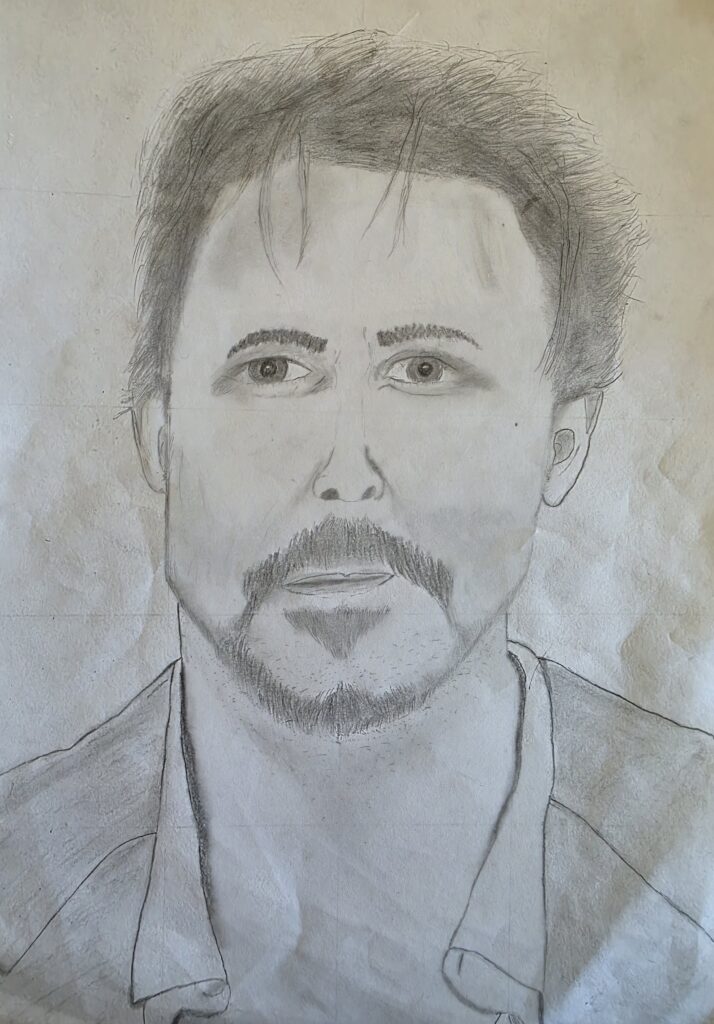 A student applies gentle tonal gradients, building up realistic contours in a pencil-drawn self-portrait_
