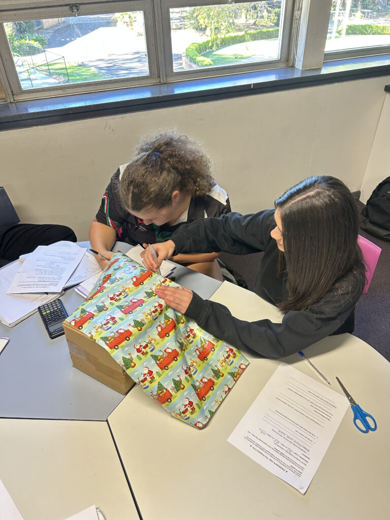 Year 10 students collaborated confidently, applying critical thinking to develop efficient wrapping solutions.