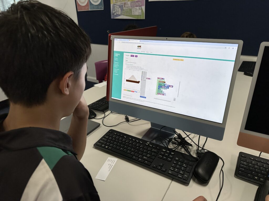 Focused students embraced challenging coding tasks, demonstrating resilience, critical thinking, and outstanding digital learning success.
