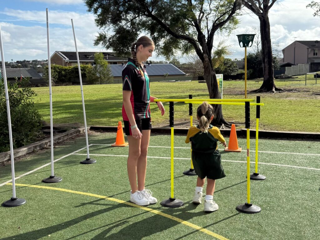 Student leaders mentor young athletes, building confidence and fundamental movement skills.