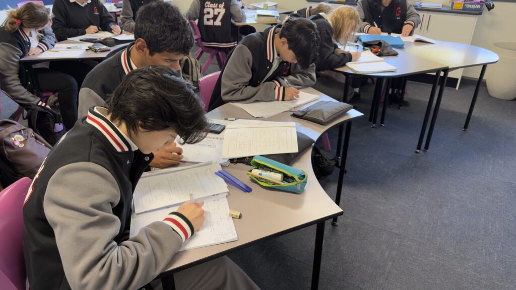 Year 11 mathematicians demonstrate focus and perseverance while tackling advanced problem-solving challenges