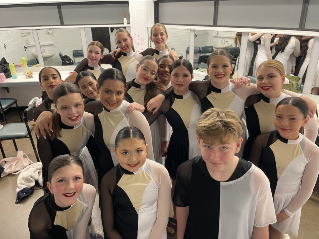 Year 7 dancers unite backstage, showcasing teamwork, confidence, and performance excellence.
