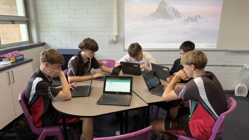 Year 9 students collaborate confidently, applying digital skills to solve mathematical challenges.IMG_6889